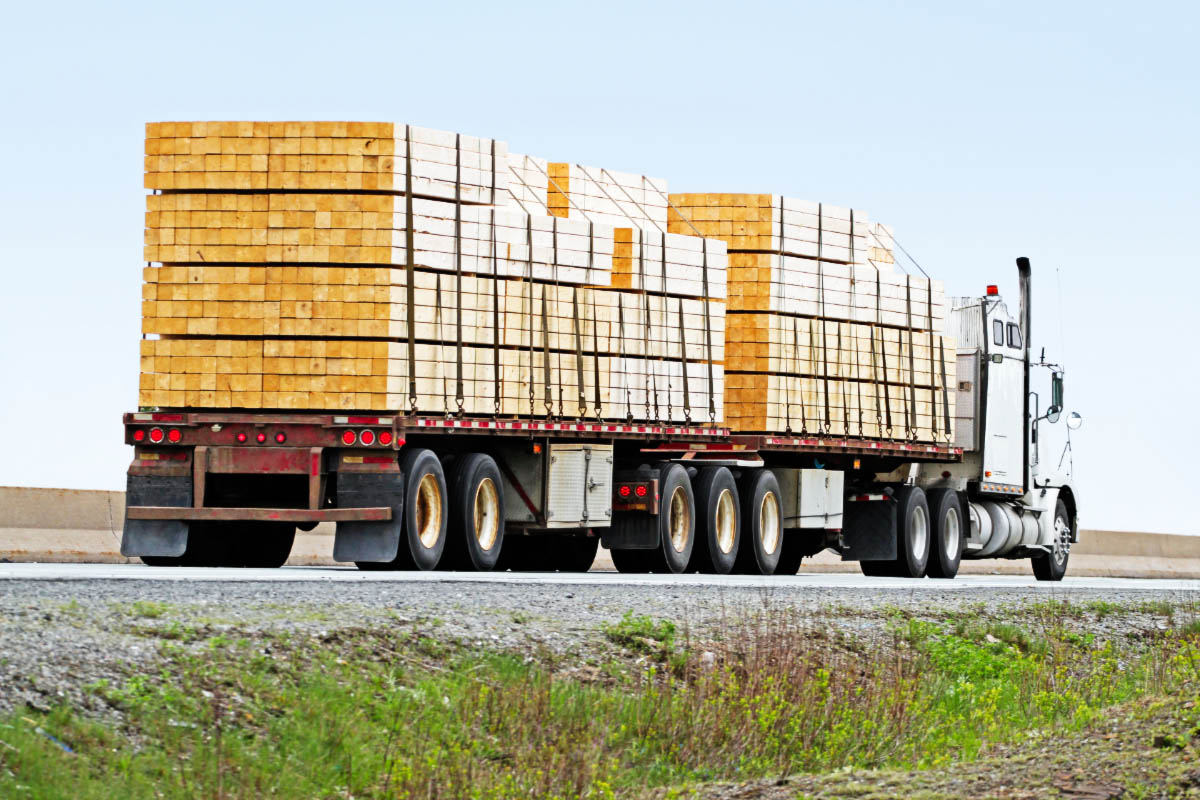 Semi-flatbed truck hauling lumber
