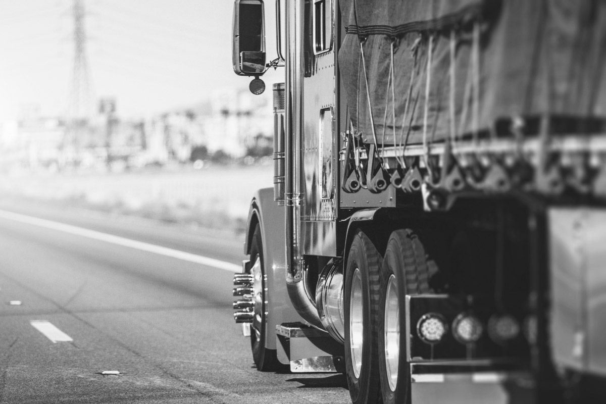 A black and white photo of the side of a truck